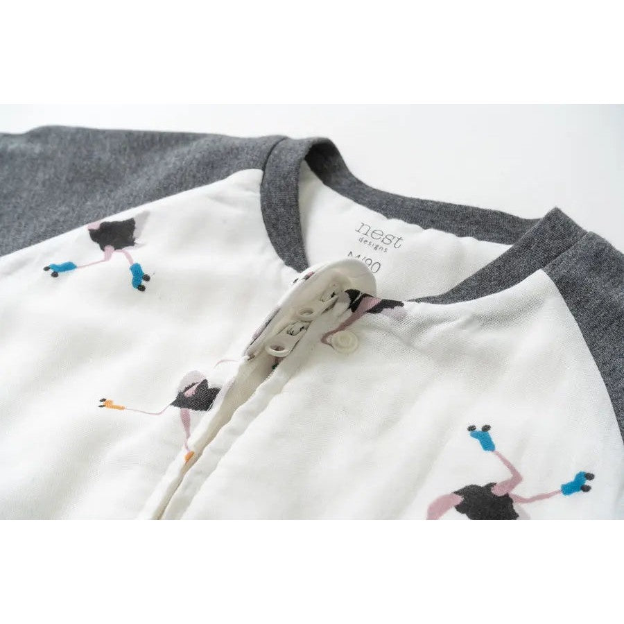 Nest Designs Bamboo Long Sleeve Footed Sleep Bag 1.0 Tog Let's Roll; white body with gray sleeves and playful print, front placket fastened.