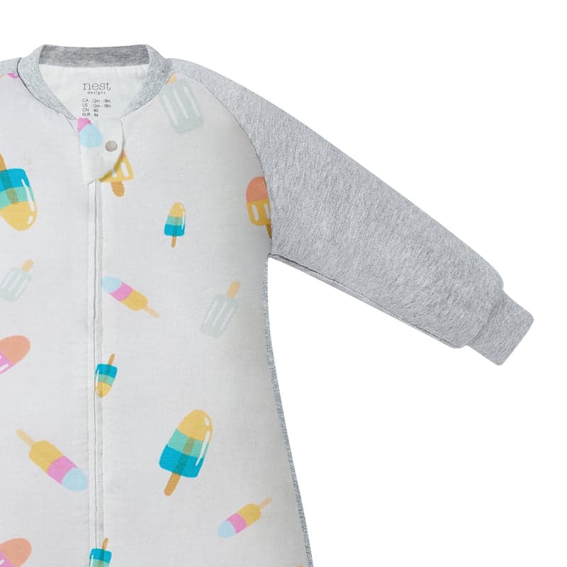 Nest Designs bamboo long-sleeve footed sleep bag in white with colorful popsicle print and grey sleeves, zipper closed.