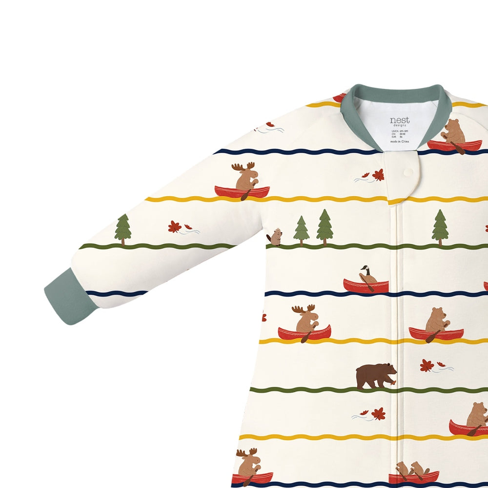 Nest Designs Bamboo Long Sleeve Footed Sleep Bag 1.0 Tog Canoe Do It, cream with canoe/bear forest motif; shows footed design and front zipper.