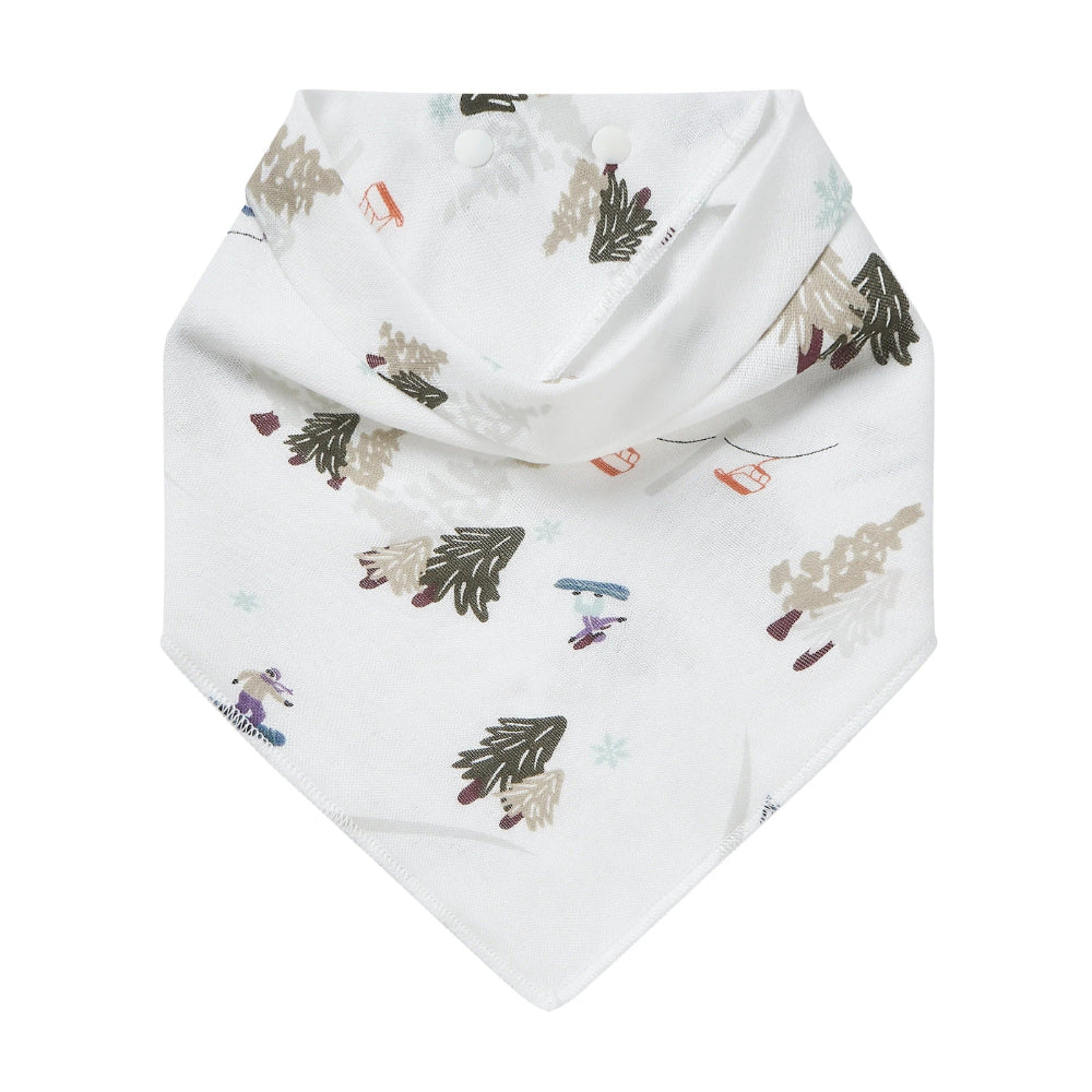Nest Designs Bamboo Muslin Baby Bandana Bib Chills N' Thrills, white with forest tree print and snap closures.