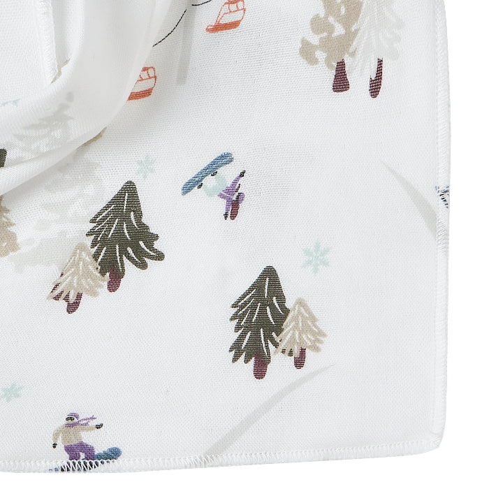 Nest Designs Bamboo Muslin Baby Bandana Bib Chills N' Thrills laid flat in white with woodland trees print.