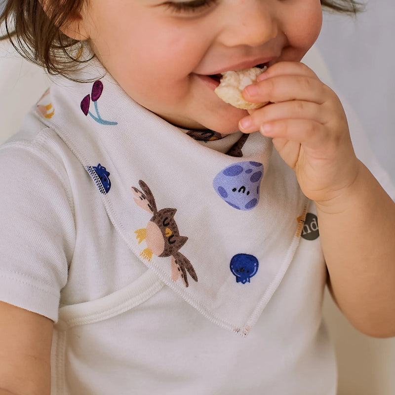Nest Designs bamboo muslin baby bandana bib Evening Bounty with playful animal prints