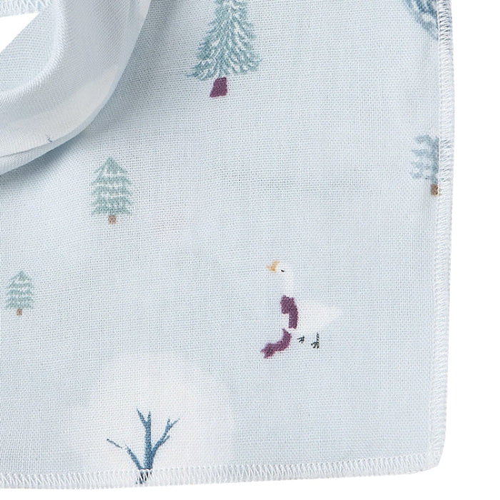 Nest Designs Bamboo Muslin Baby Bandana Bib Snowy Snuggles, light blue with trees, laid flat to show soft fabric.