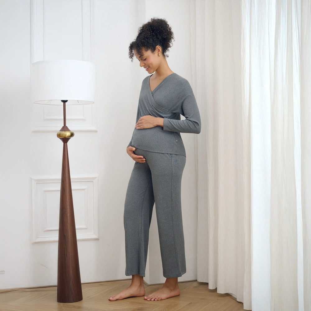 Pregnant woman wearing gray bamboo-knit nursing top with wrap V-neck and matching gray pants.