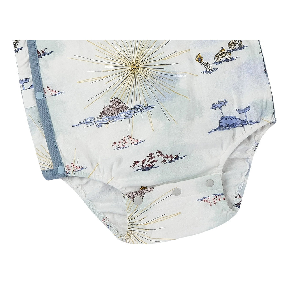 Nest Designs Bamboo Short Sleeve Kimono Onesie Ocean Wonders, pale blue ocean scene print with side-snap closure being fastened.