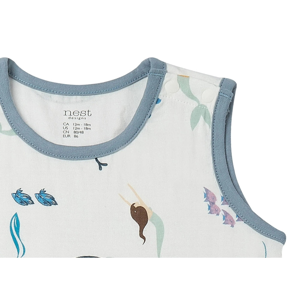 Nest Designs Bamboo Sleeveless Romper Splish Splash worn by baby, white fabric with blue trim and playful prints.