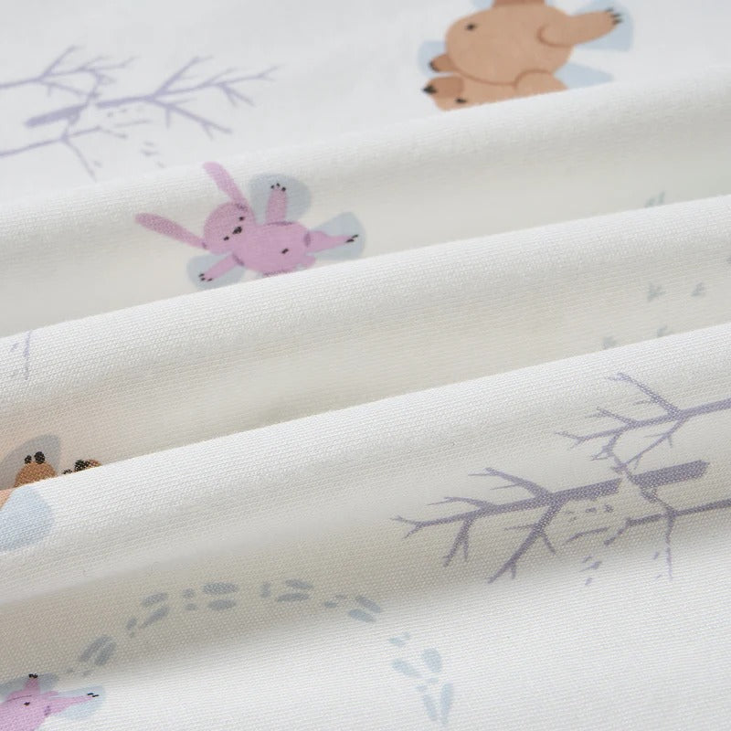 Nest Designs Bamboo Toddler Pillow with Pillowcase Snow Angels, white fabric showing pastel bunnies and snowflakes.