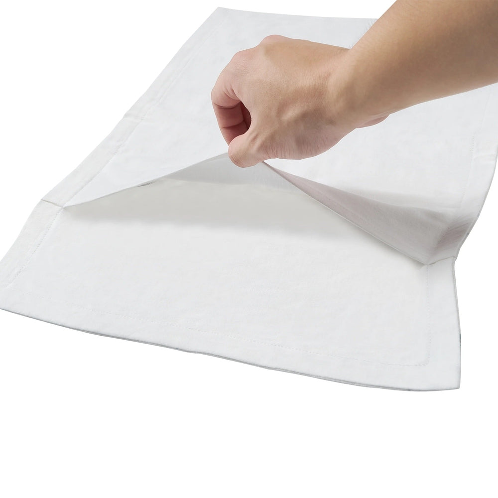 Nest Designs Bamboo Toddler Pillowcase Chills N' Thrills in white, hand lifting the corner to show the envelope opening.