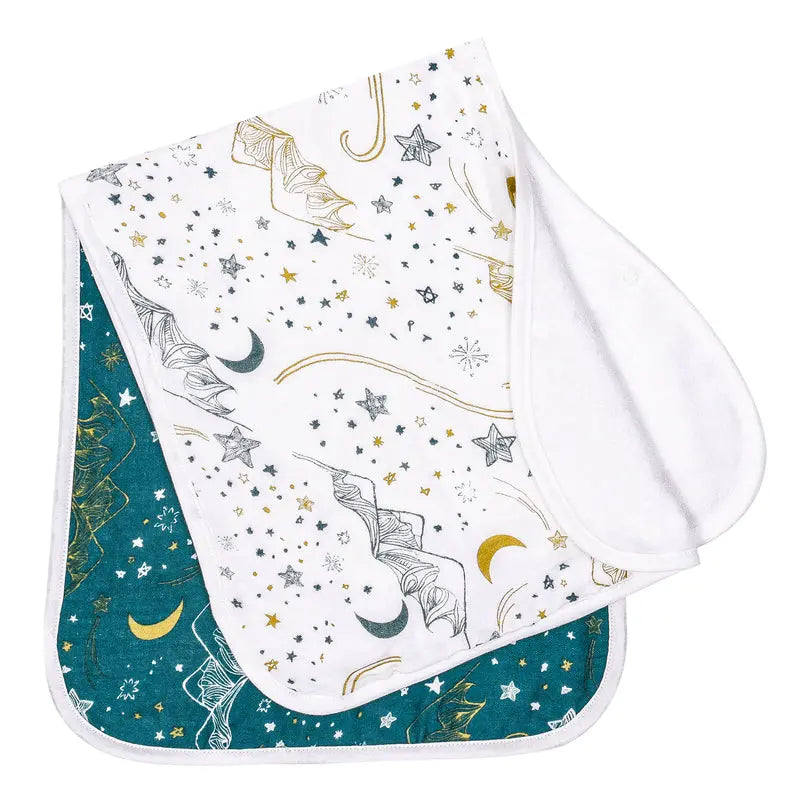 Nest Designs Burp'N Bib 2-pack: white patterned bibs with moons/stars and teal reverses, laid flat.