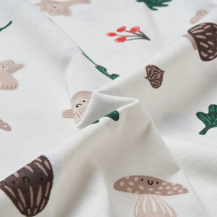Nest Designs cotton waterproof baby change pad, white fabric with whimsical mushroom pattern