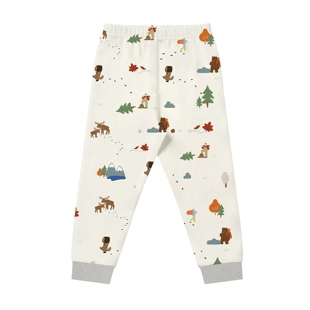 Nest Designs Timber long-sleeve pajama set pants in cream with woodland characters and dotted trails.