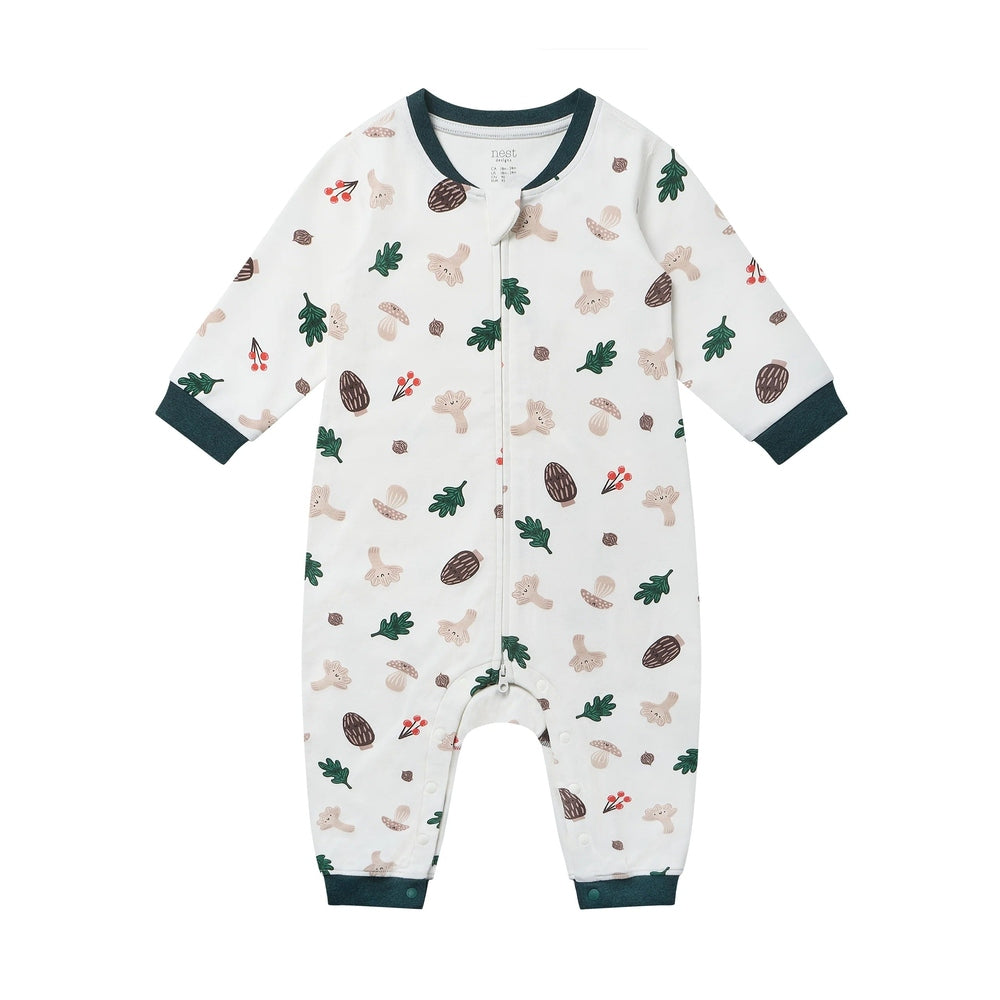 Nest Designs Forest Forage long-sleeve baby romper in white with dark green cuffs and forest print.