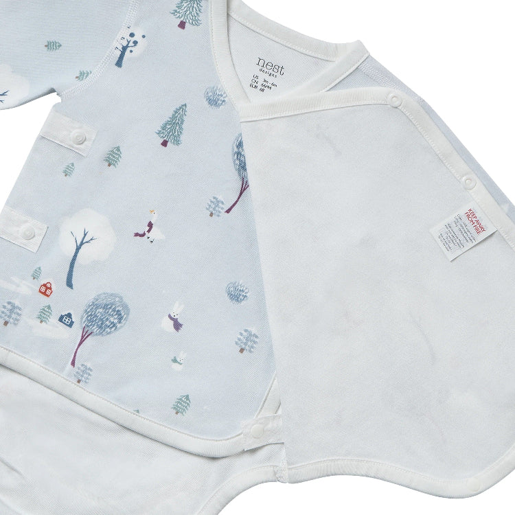 Nest Designs Organic Cotton Long Sleeve Kimono Onesie Snowy Snuggles, pale blue with winter pattern and side-snap wrap closure.