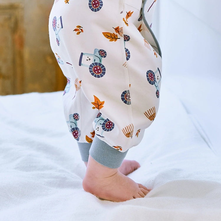 Nest Designs Organic Cotton long-sleeve kimono romper on the farm; cream fabric with blue tractors and orange leaves