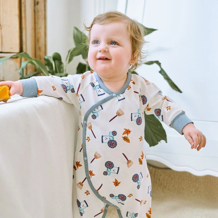 Nest Designs organic cotton long-sleeve kimono romper for babies, white with blue-gray trim and farm-print motifs.