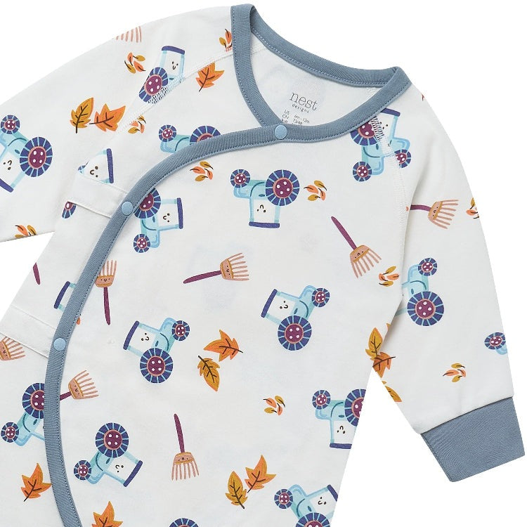 Nest Designs organic cotton long-sleeve kimono romper on the farm; white with blue trim and playful tractors