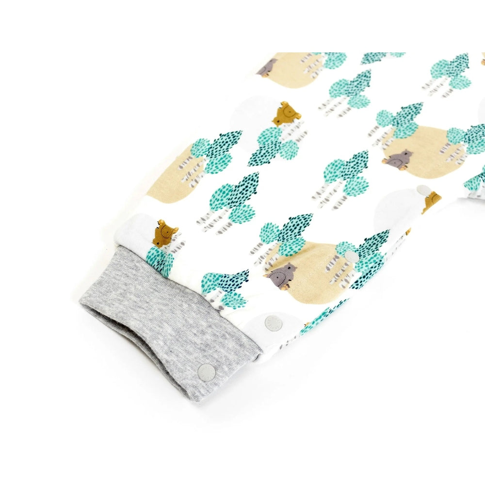 Nest Designs Organic Cotton Long Sleeve Sleep Suit 1.0 Tog, white with bears and teal trees; gray cuffs show snug sleeves and easy snap closures.