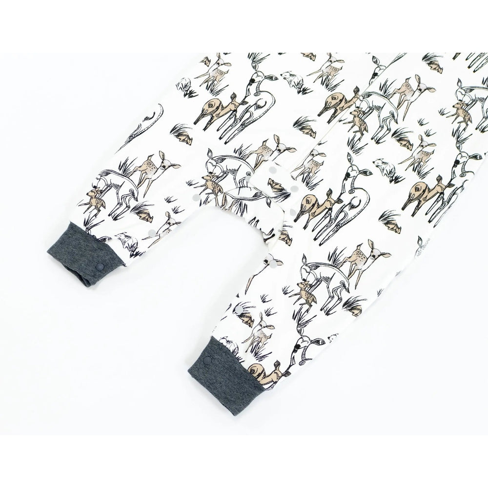 Nest Designs Organic Cotton Long Sleeve Sleep Suit 1.0 Tog, white with deer print and gray cuffs, shown on a baby