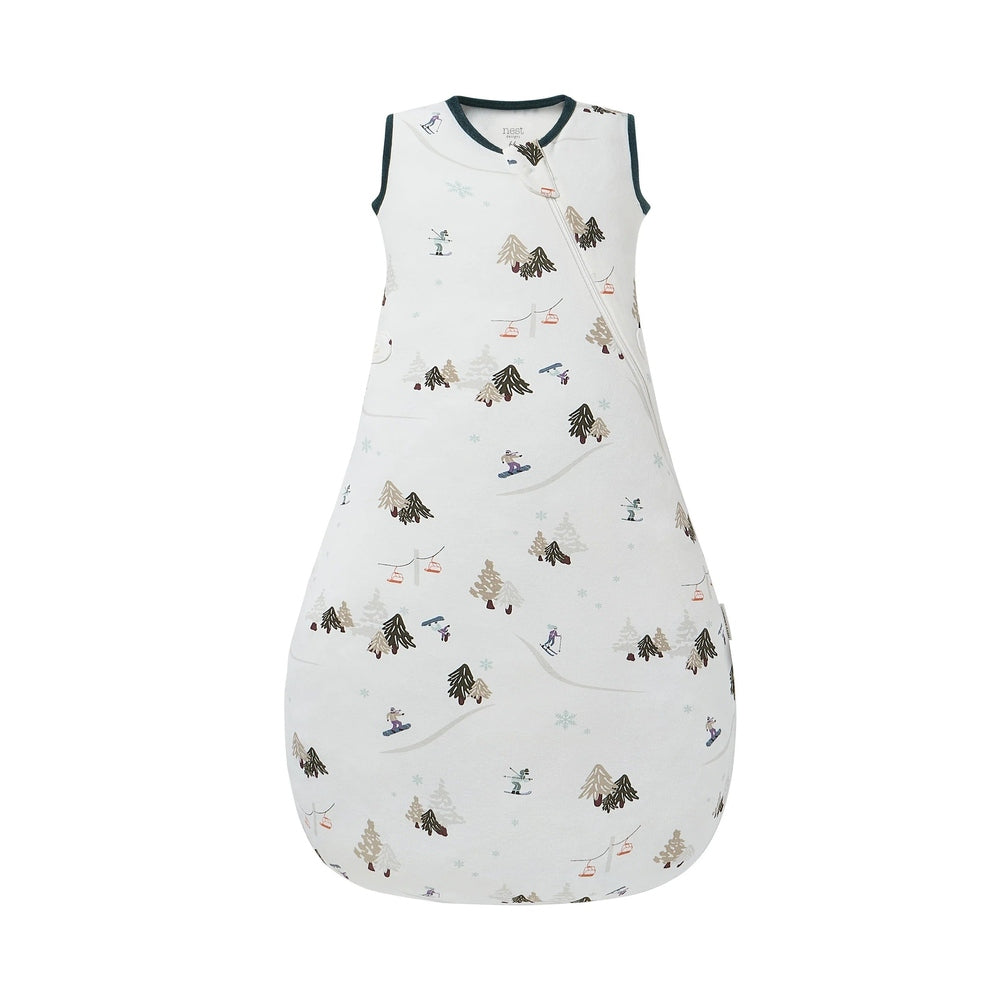 Nest Designs Organic Cotton Startle Stop Sleep Bag 0.5 Tog Chills N' Thrills, white with winter trees, shown flat with diagonal zip.