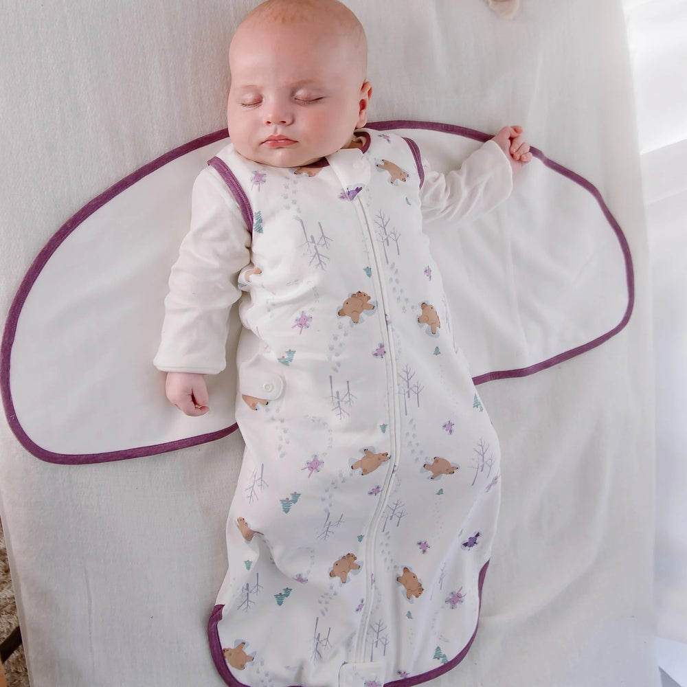 Nest Designs Startle Stop Sleep Bag 0.5 Tog Snow Angels, cream sleep sack with purple trim, baby sleeping.