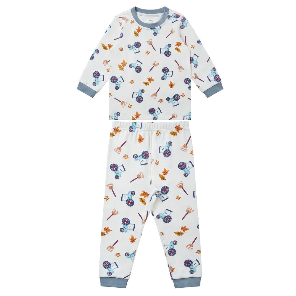 Nest Designs organic cotton two-piece pajama set for kids, white with blue cuffs and farm prints