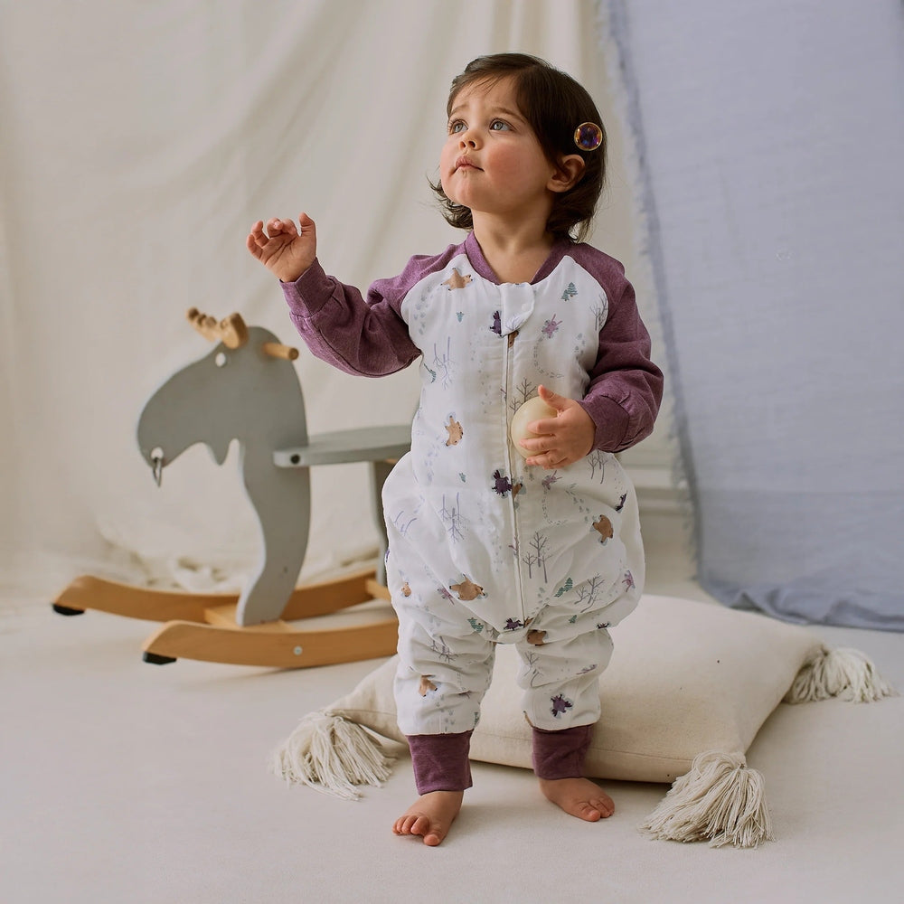 Nest Designs Raglan Bamboo Footed Sleep Bag 2.5 Tog Snowy Angels; toddler stands in