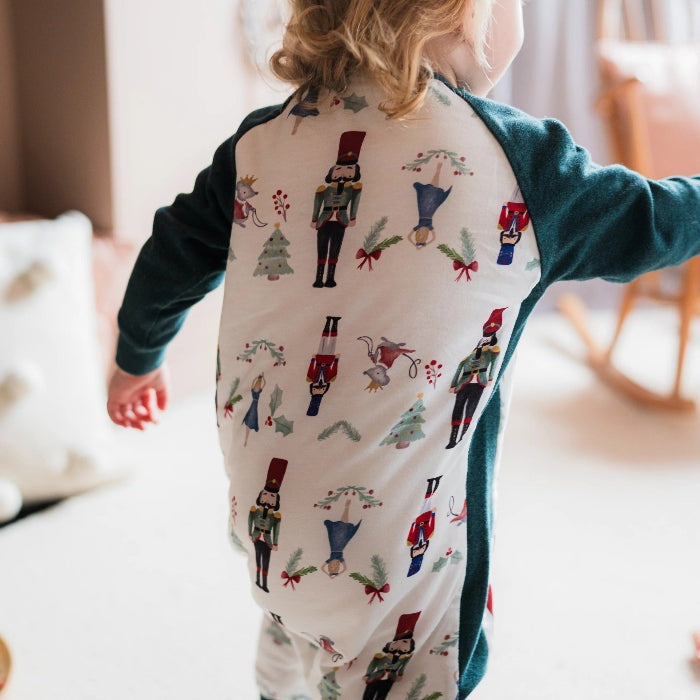 Nest Designs Raglan Bamboo Long Sleeve Footed Sleep Bag 2.5 Tog Nutcracker worn by toddler in cream and teal.