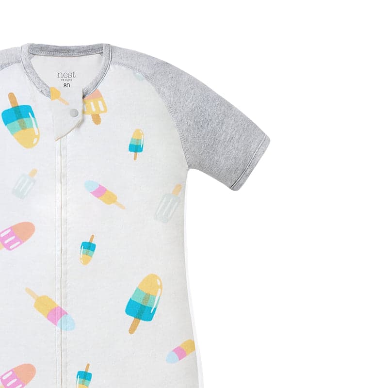 Nest Designs Raglan Bamboo Pima Short Sleeve Footed Sleep Bag 0.6 Tog Summer Pops in white with gray sleeves and a front zipper.