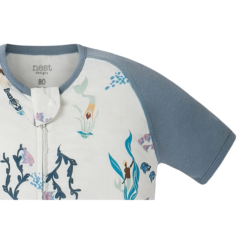 Nest Designs raglan bamboo pima sleep bag 0.6 Tog Splish Splash, white with blue aquatic print and blue sleeves, front snap placket.