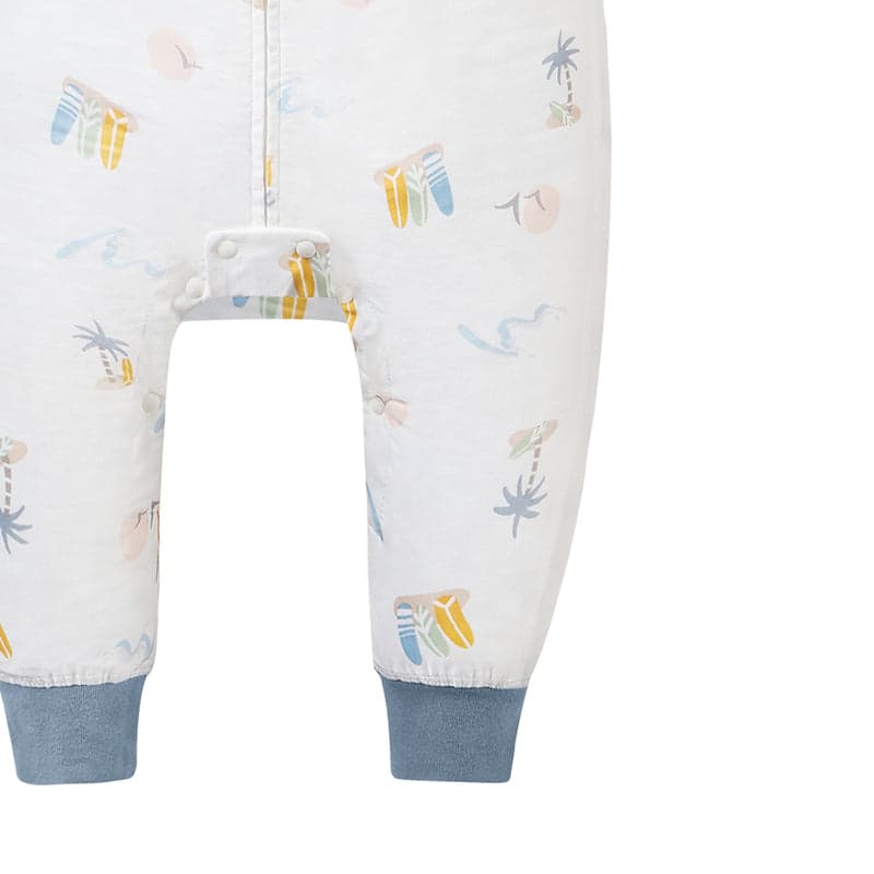 Nest Designs Raglan Bamboo Pima Short Sleeve Footed Sleep Bag 0.6 Tog in pastel waves with blue cuffs.