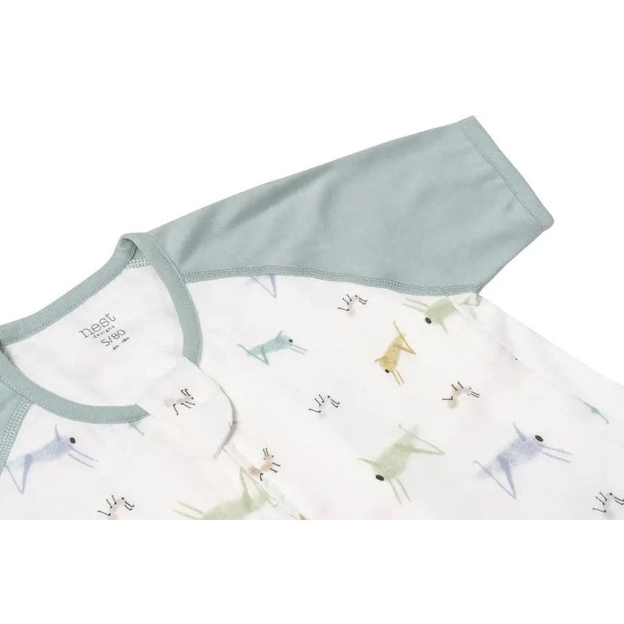 Nest Designs Raglan Bamboo Pima Sleep Suit 0.6 Tog, white with pastel bug print and blue sleeves, laid flat.