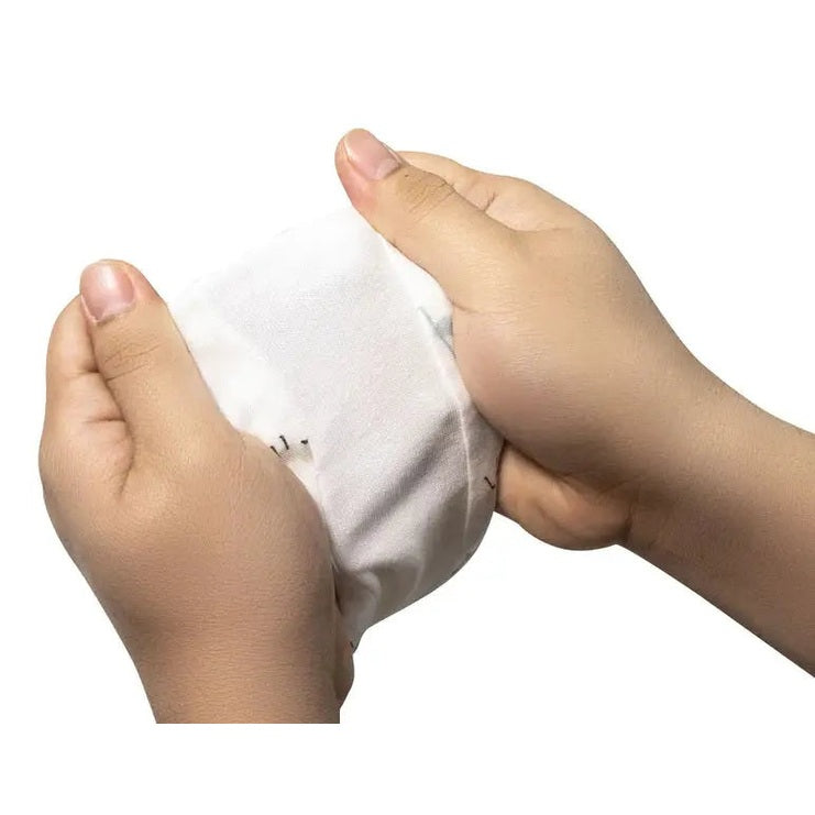 Nest Designs Raglan Bamboo Pima short-sleeve sleep suit 0.6 Tog; hands gently stretch the soft white fabric.