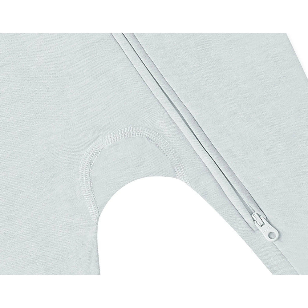 Nest Designs Tanboocel long-sleeve footed sleeper in Pantone Ice Flow, pale blue fabric with visible leg zipper.