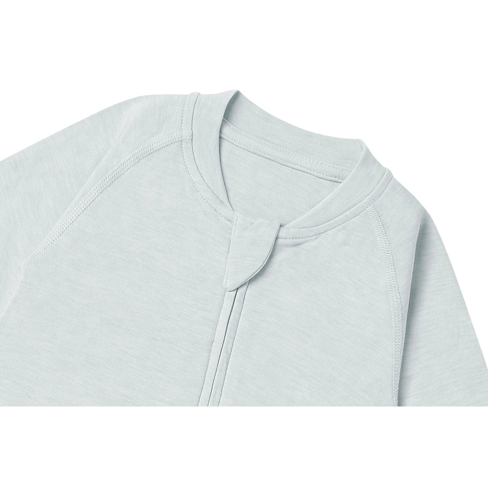 Nest Designs Tanboocel Long Sleeve Footed Sleeper Pantone Ice Flow in pale blue, front knot detail on soft fabric.