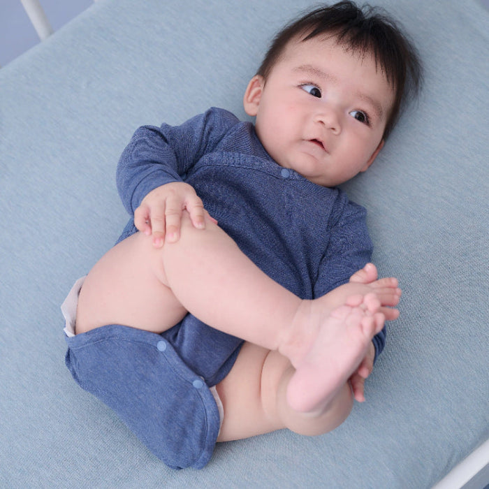 Baby in Nest Designs Tanboocel long-sleeve kimono onesie in vintage indigo on blue blanket.