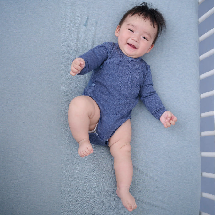 Nest Designs Tanboocel long-sleeve kimono onesie in vintage indigo worn by baby