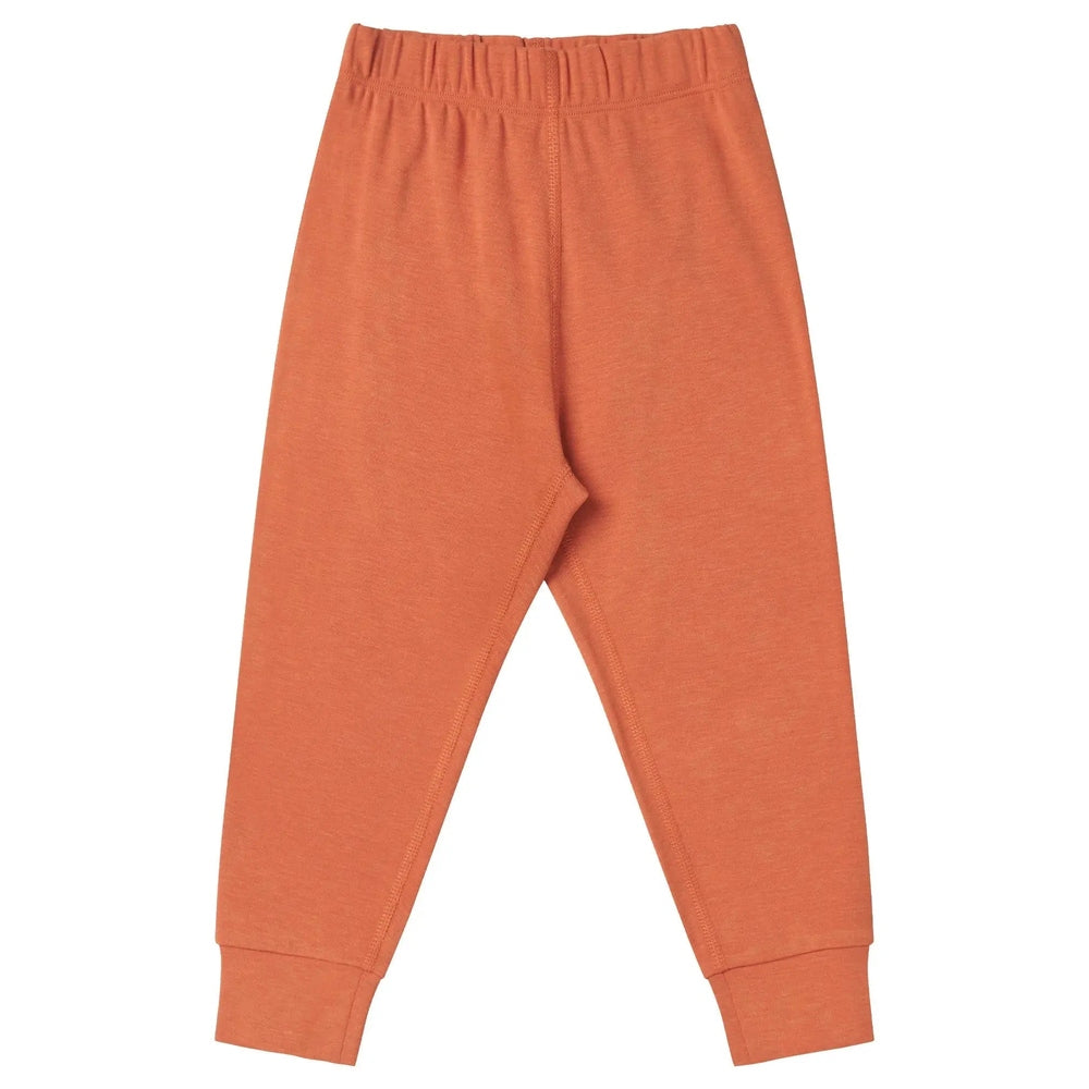 Nest Designs Tanboocel Pants Pantone Apricot Orange with gathered elastic waistband and cuffed ankles, laid flat.