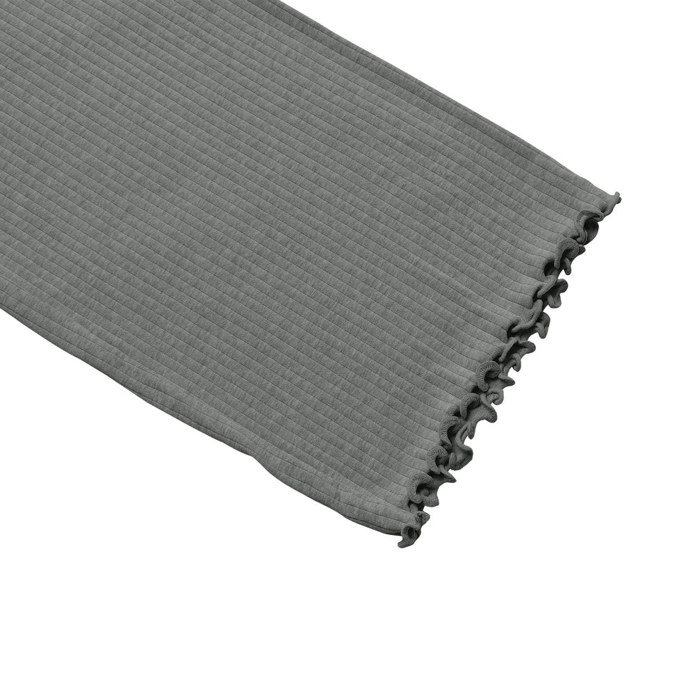 Grey rib-knit wide-leg pants leg close-up with vertical ribs and ruched hem.