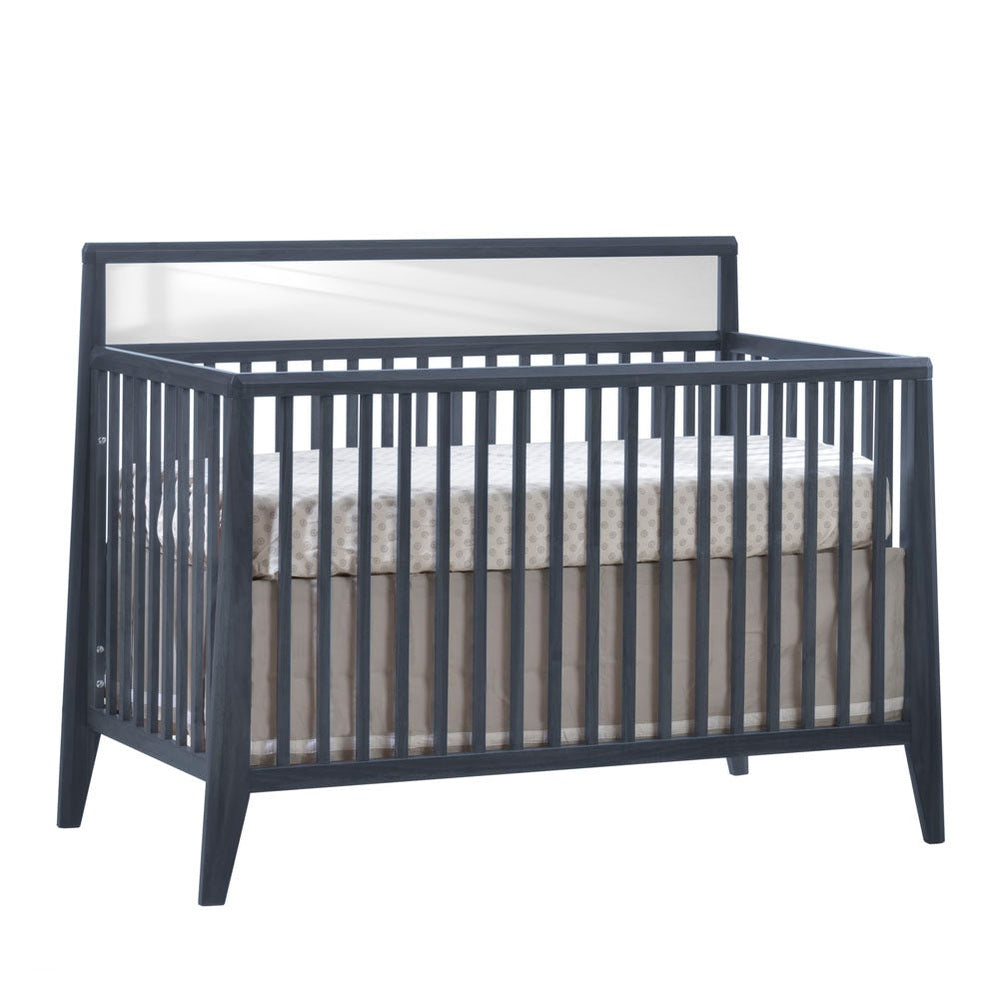 Nest Flexx Premium Convertible Crib navy with slatted sides and solid back panel, mattress in place.