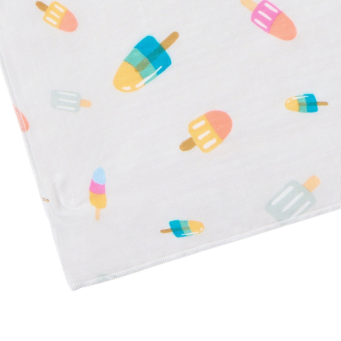 A close-up of a white fabric item, likely a baby blanket or swaddle, featuring a playful pattern of colorful popsicles and ice cream cones.