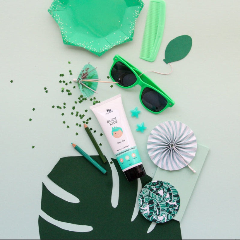 No Nasties Slick Kids Hair Gel tube beside green sunglasses among mint party decor.