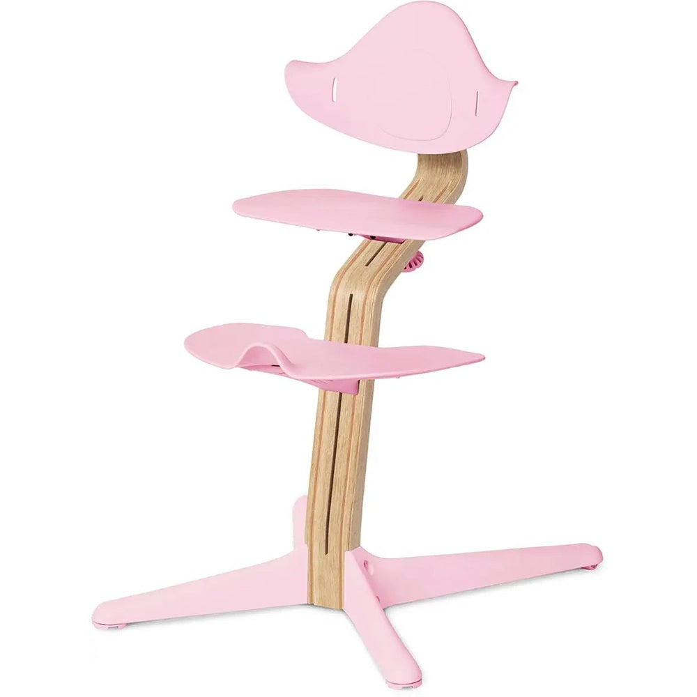 NOMI Chair high chair in pink with natural oak wood frame and pink trays shown.
