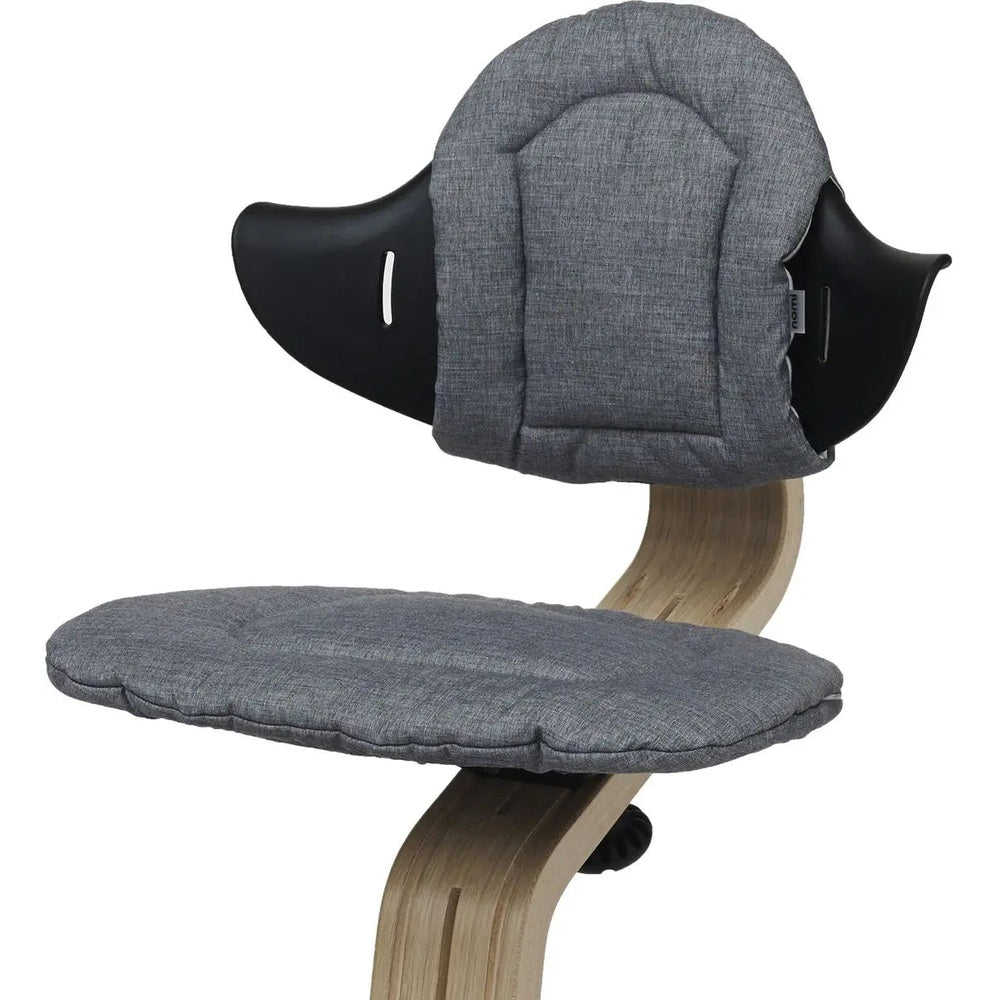NOMI Highchair Cushion in grey fabric with padded seat and backrest attached to a wooden high chair.