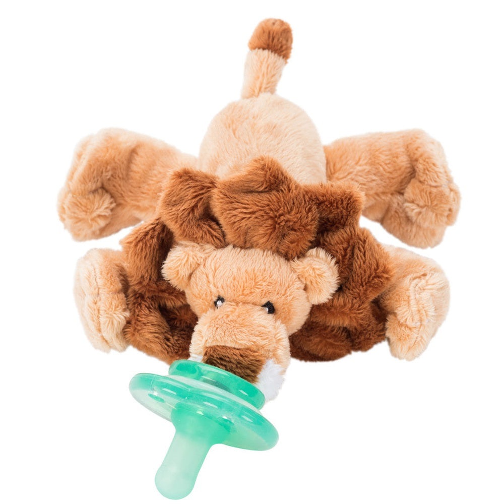 Nookums Paci-Plushies Leo Lion Buddies, soft tan plush lion holding a green pacifier in its mouth.