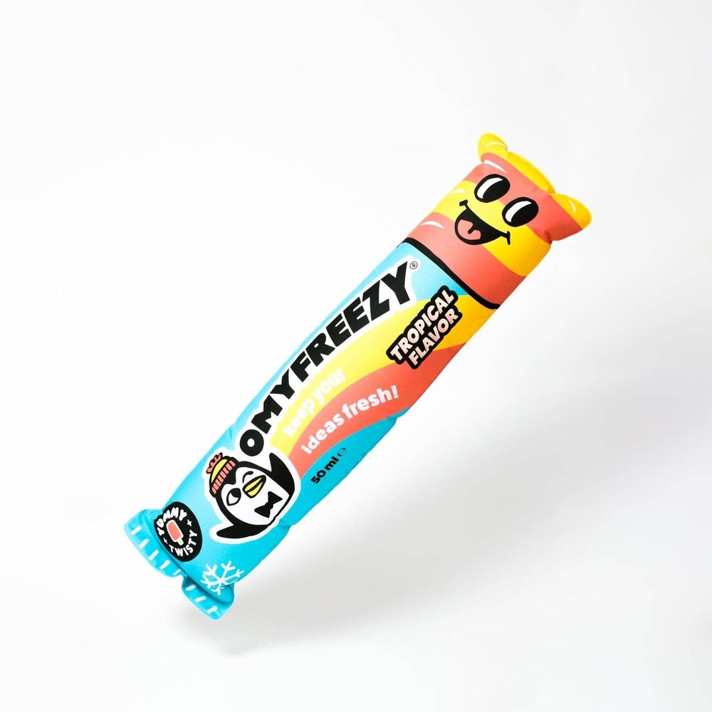 OMY Freezy giant inflatable pillow in bright blue/yellow/pink with a happy face, floating in air.