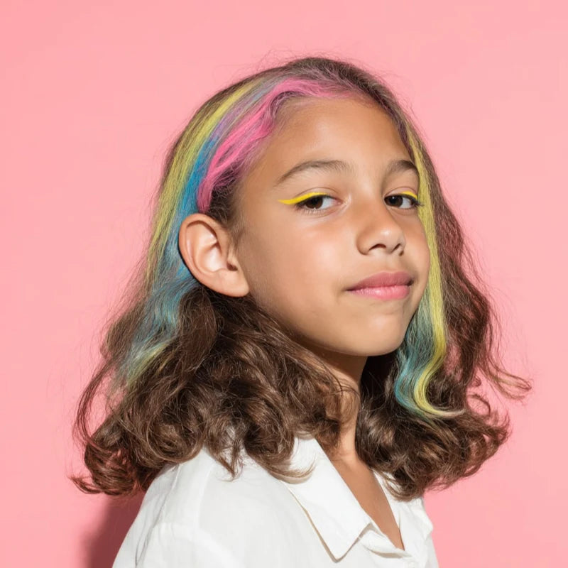 OMY - Hair Chalk: girl with rainbow hair streaks (pink, yellow, blue) against a pink background.
