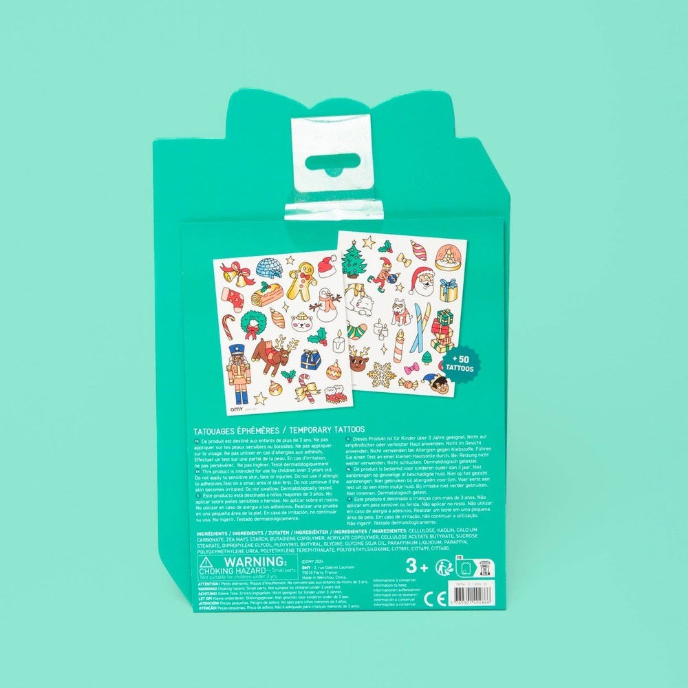 OMY Hohoho Holiday! tattoos on turquoise packaging, two sheets of colorful festive temporary tattoos.