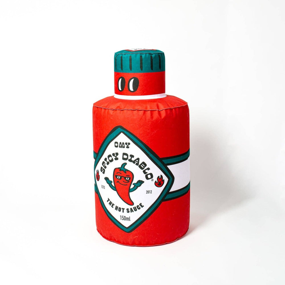 OMY Spicy Diablo Giant inflatable pillow shaped like a hot sauce bottle with a red body and teal cap.