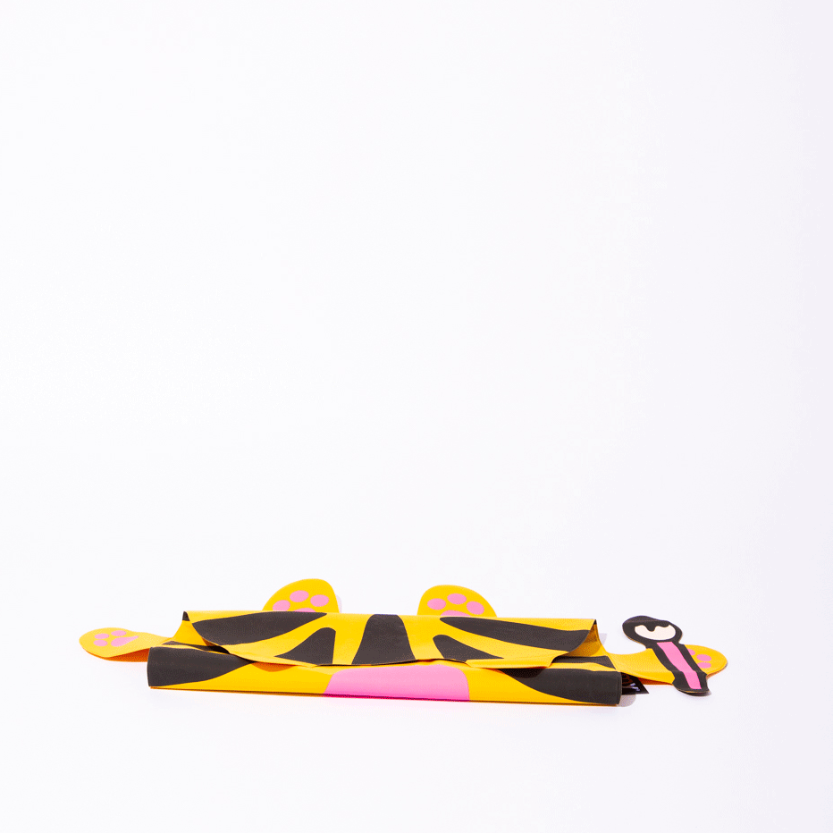 OMY Tiga Super inflatable pillow folded flat for packing, yellow tiger print with pink paw accents