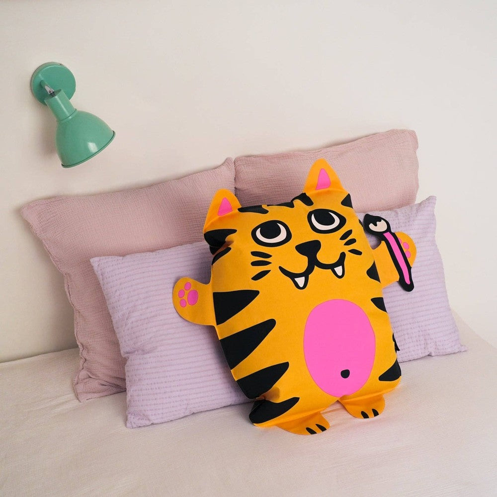 OMY Tiga Super inflatable pillow, bold tiger print, leans against pink cushions for a cheerful, cozy display.